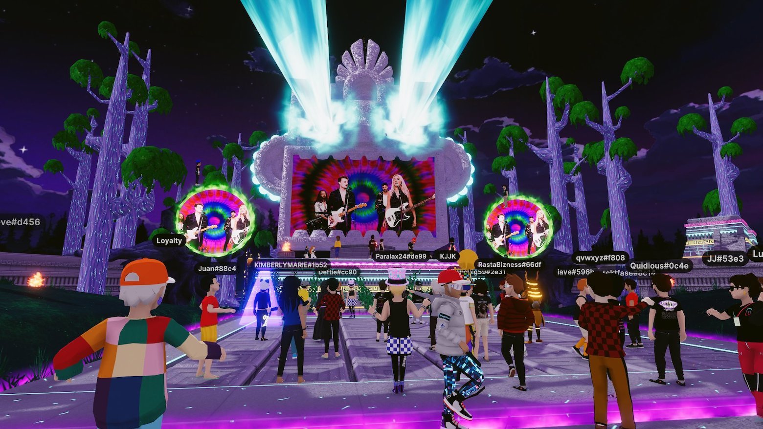 A cartoon world featuring an outdoor concert attended by 25 or so digital avatars wearing modern clothing with users’ names floating in boxes above their heads.