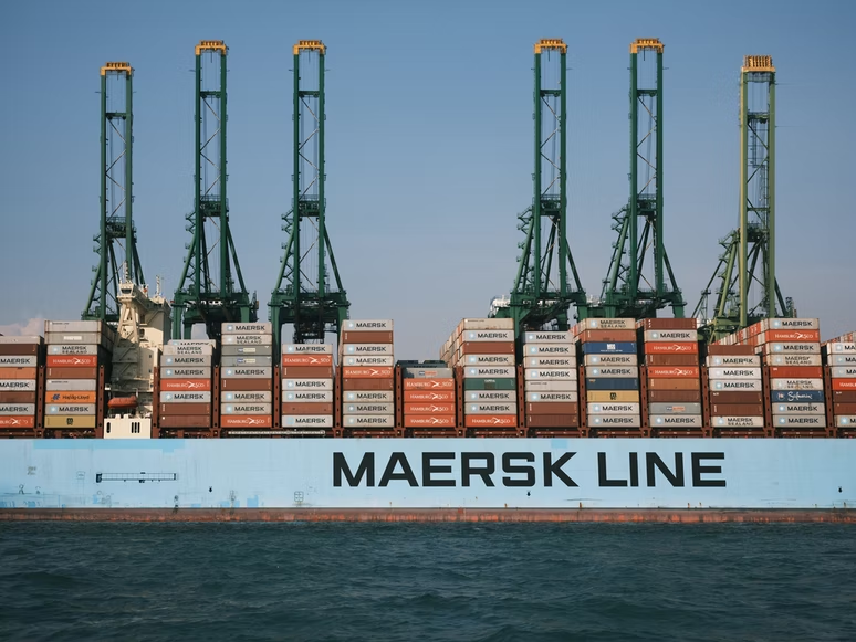 A photo of a Maersk freight ship piled high with containers.