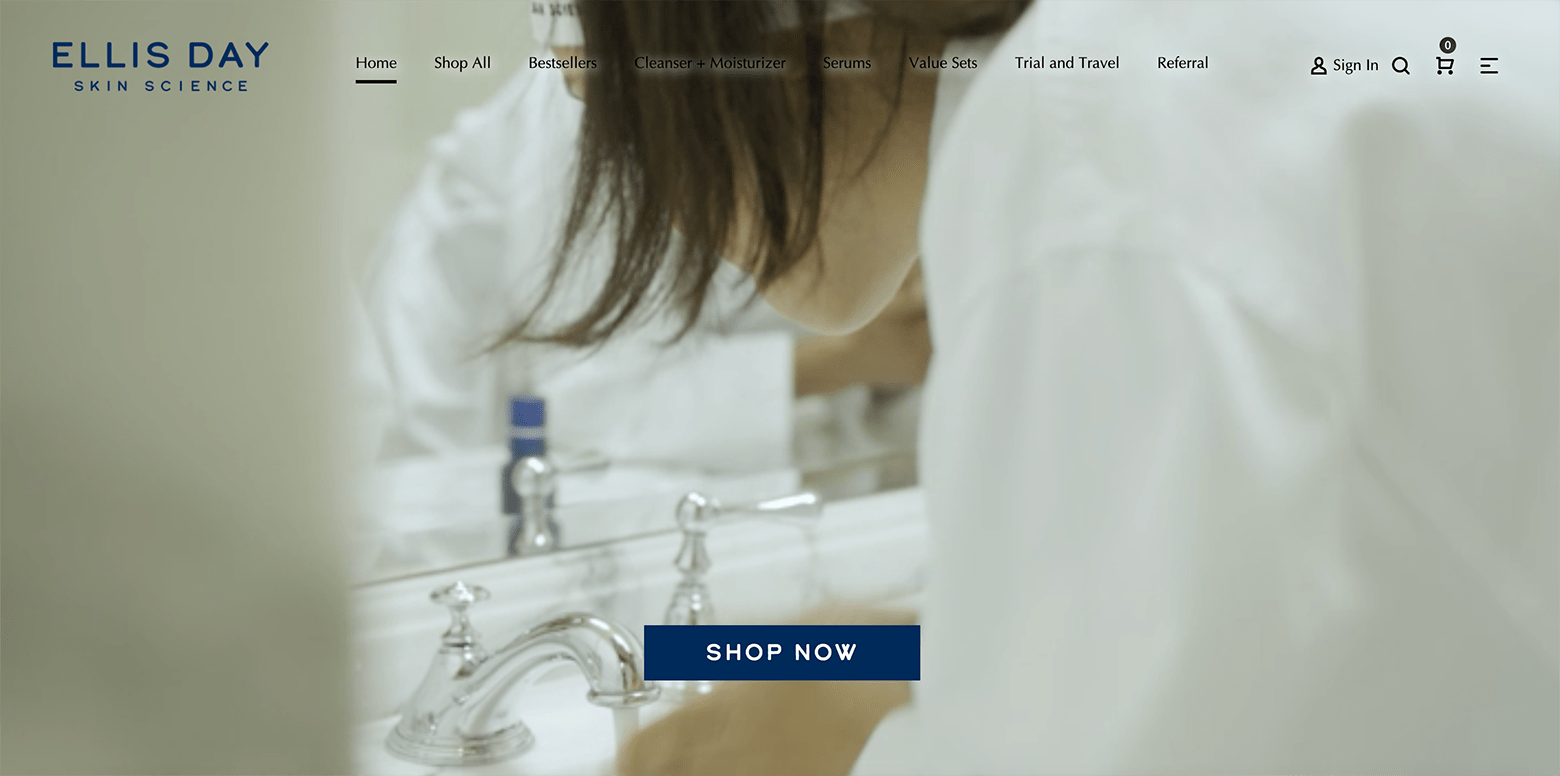 A screen shot from the Ellis Day Skin Science website, showing a man and a woman drying their faces with white towels. They are wearing white robes.