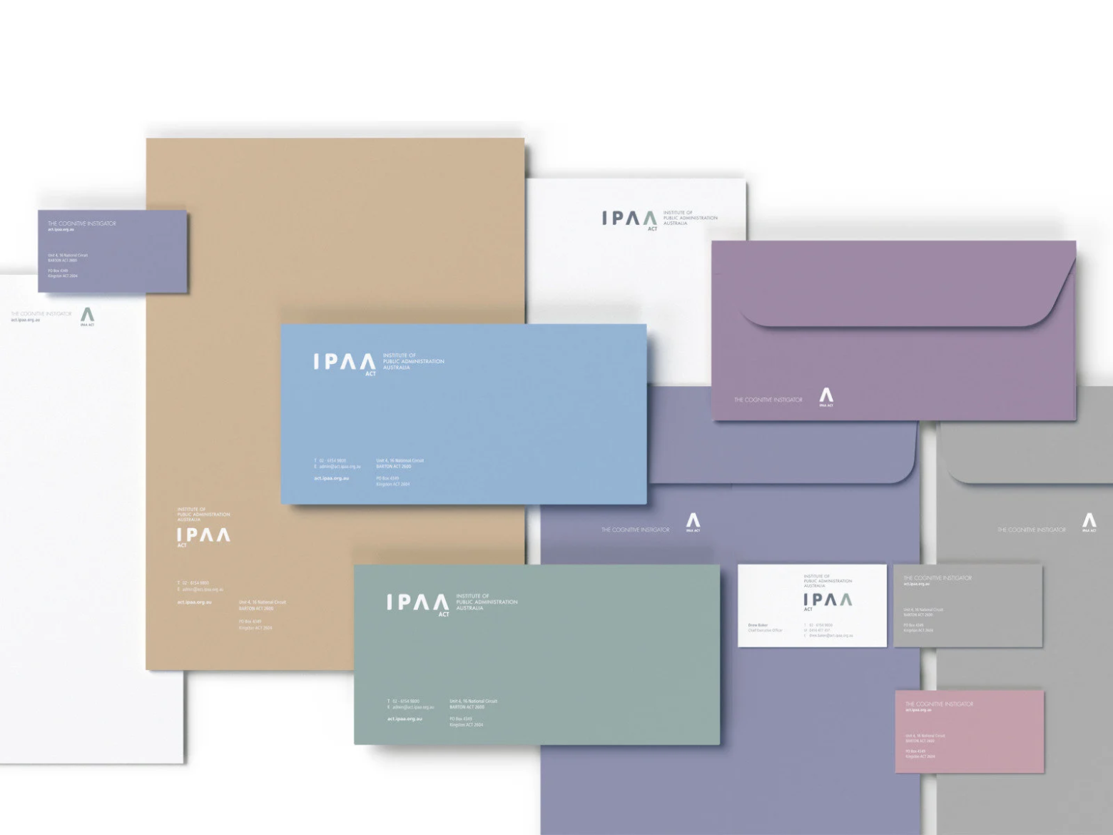 An array of IPAA stationery and business cards in various brand colors, decorated with IPAA logos, sample copy, and letterhead styles.