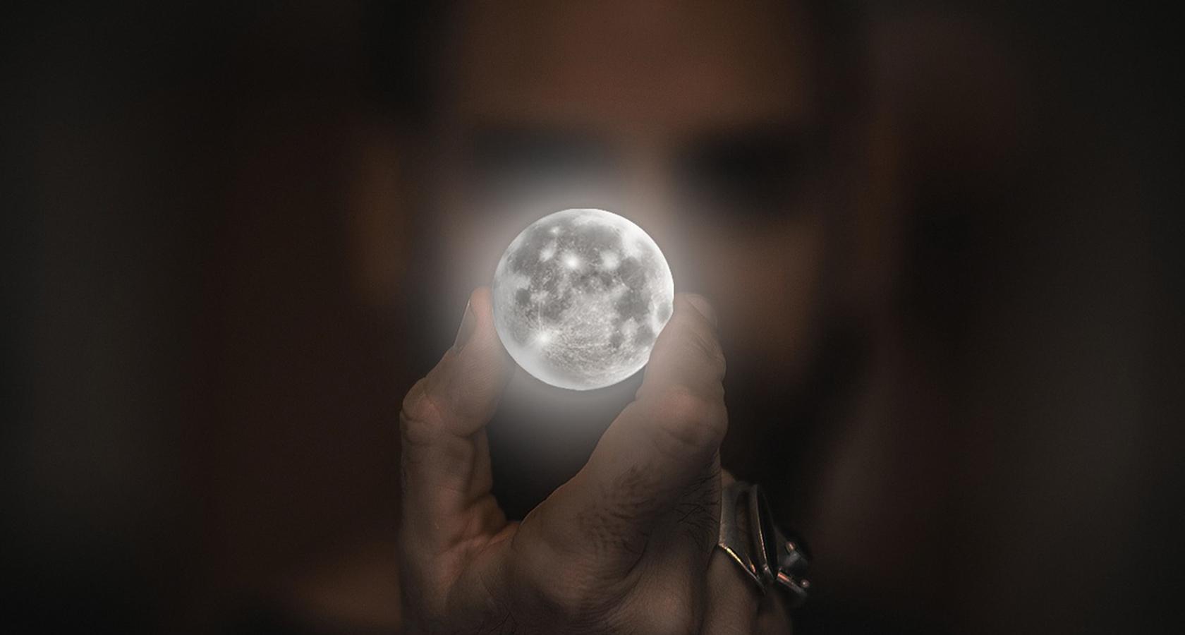 Man holding a non-realistic moon