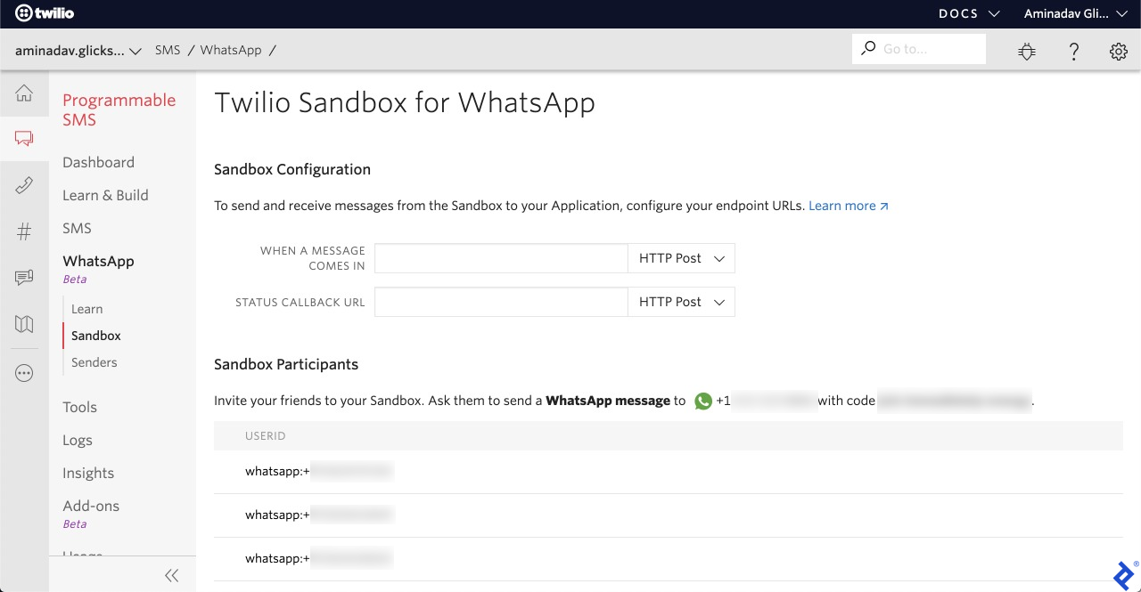 A screenshot of the "Twilio Sandbox for WhatsApp" page. The Sandbox Configuration section has two endpoint URL fields, for "when a message comes in" and "status callback URL." The Sandbox Participants section lists user ids (in the format "whatsapp:" followed by a phone number) and has the same instructions as before on how to invite friends to the sandbox via sending a special message.