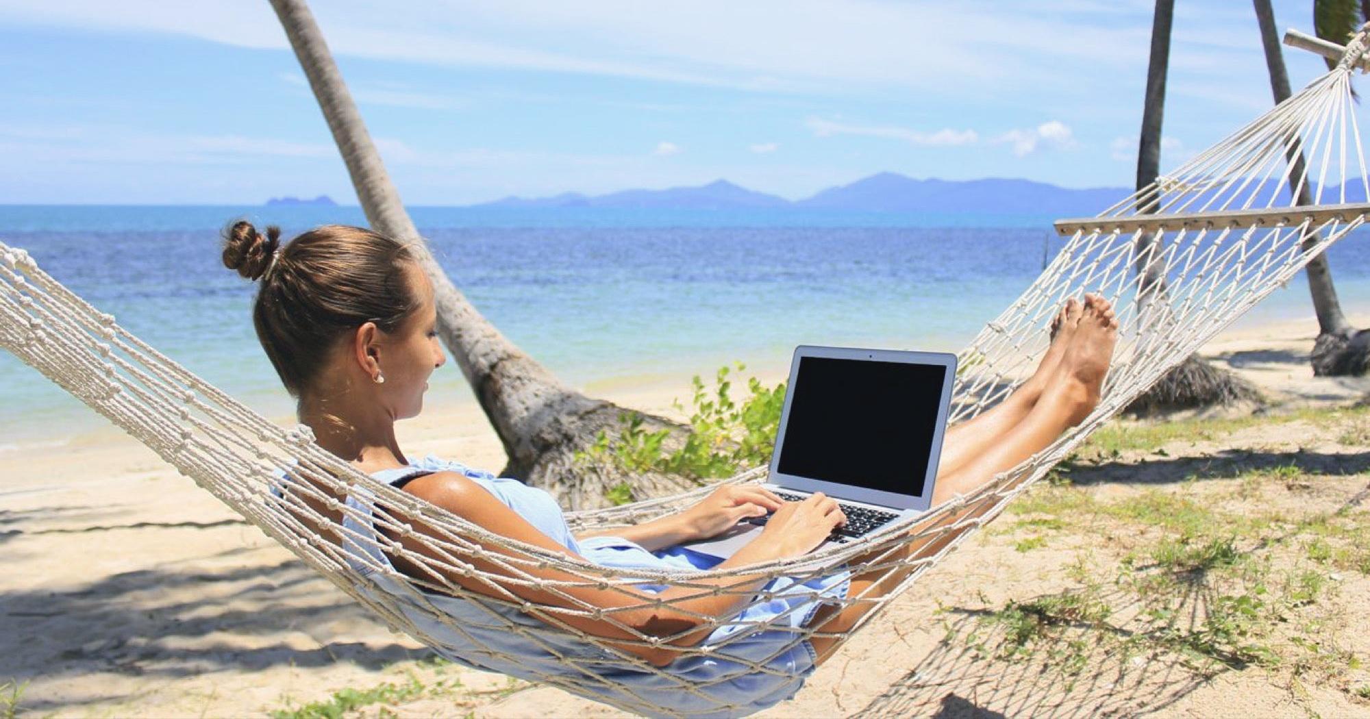 Digital nomad working on the beach.