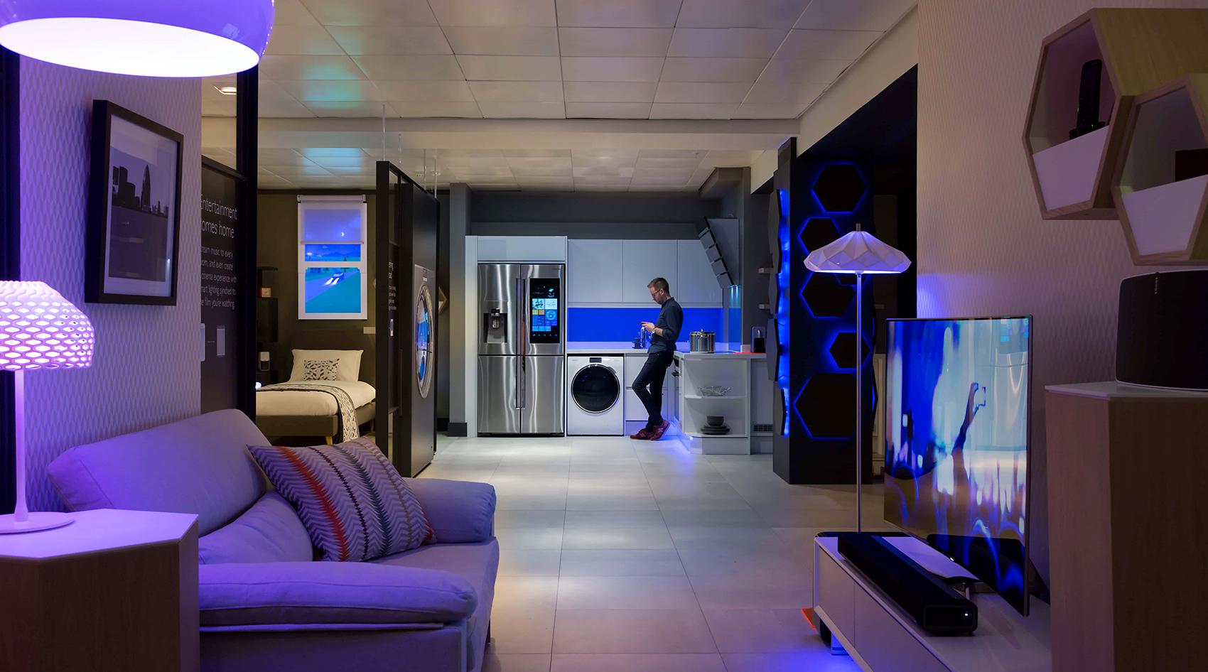 IoT smart home with a man in the kitchen.