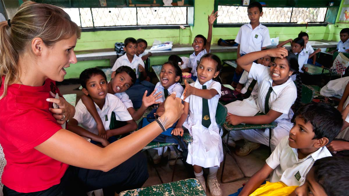 Image of an IBM Corps team member teaching children