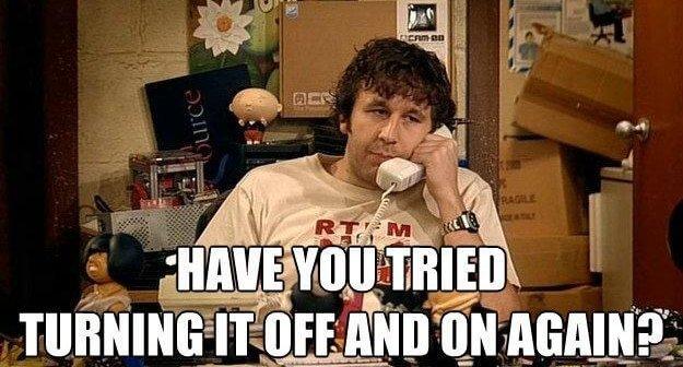 Meme of the IT Crowd TV show with their iconic tagline: Have you tried turning it off and on again?