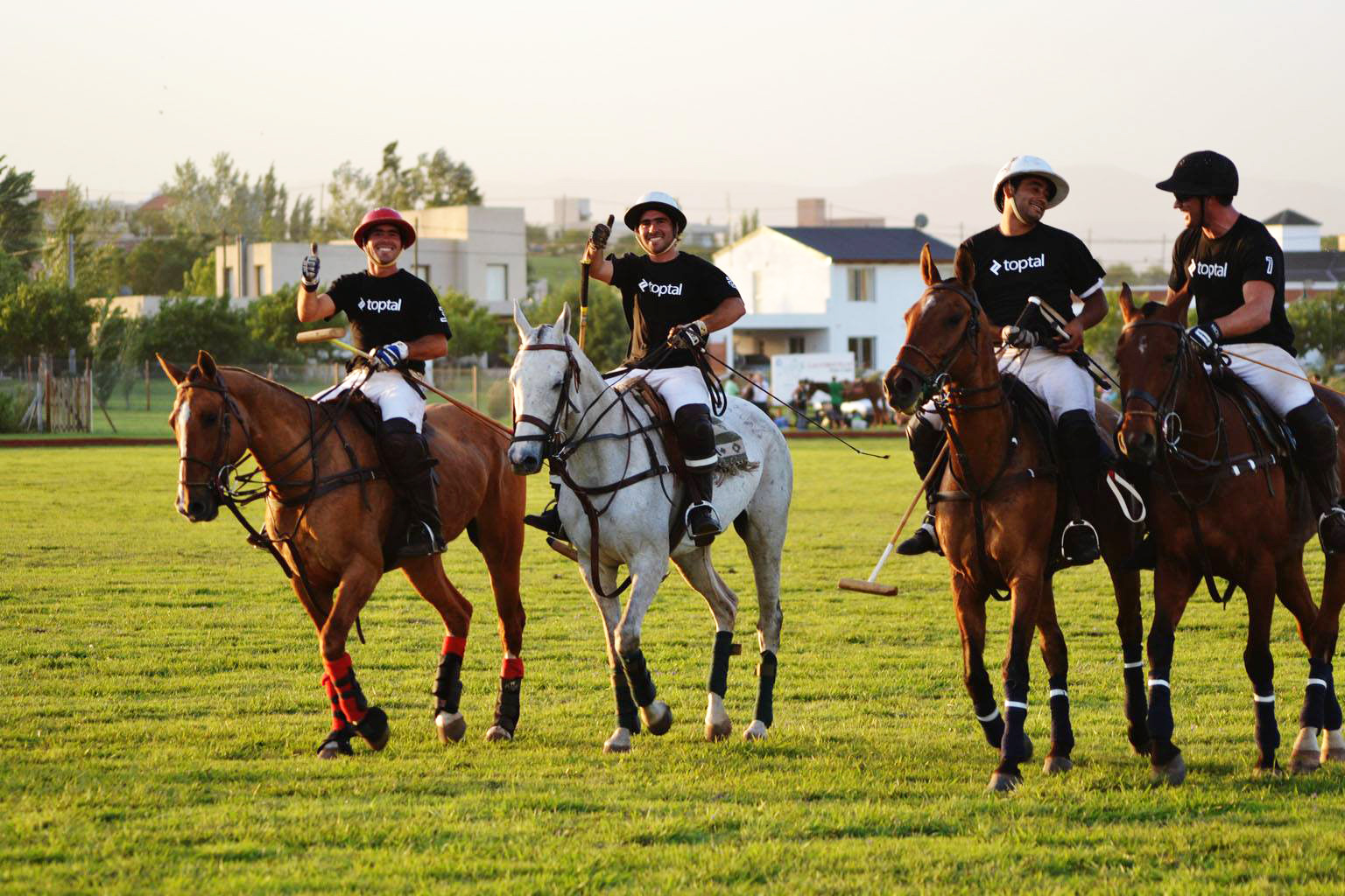 How to travel while working the right way? Play polo in Argentina with a company t-shirt on.